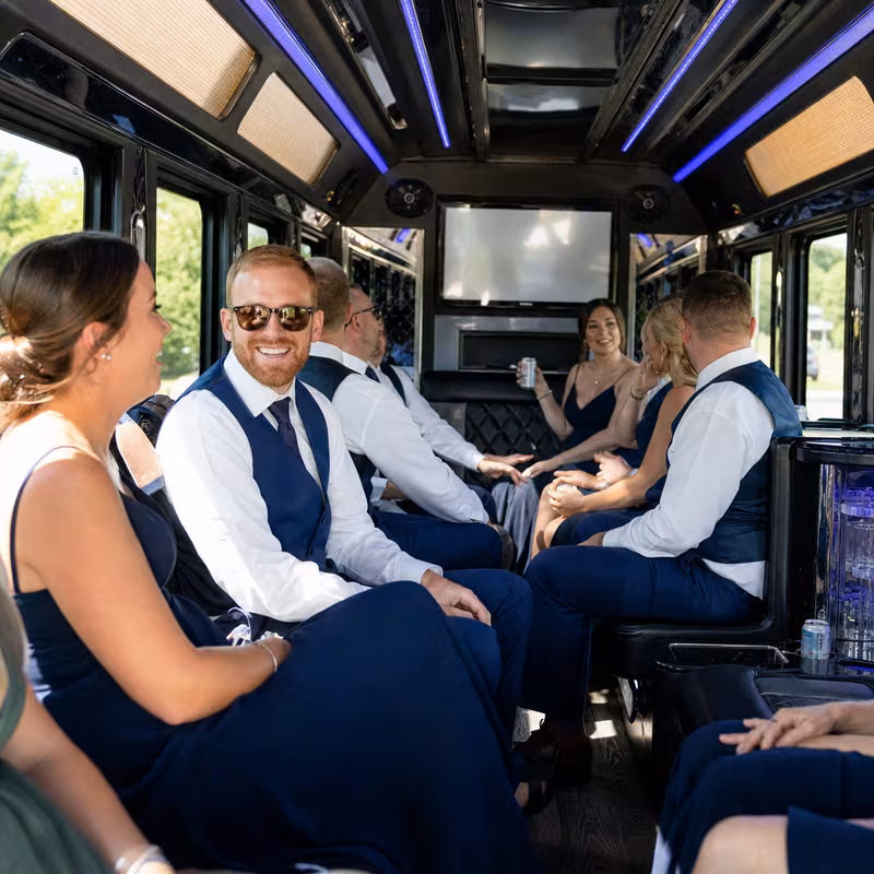 Wedding guests seated inside a Indianapolis party bus