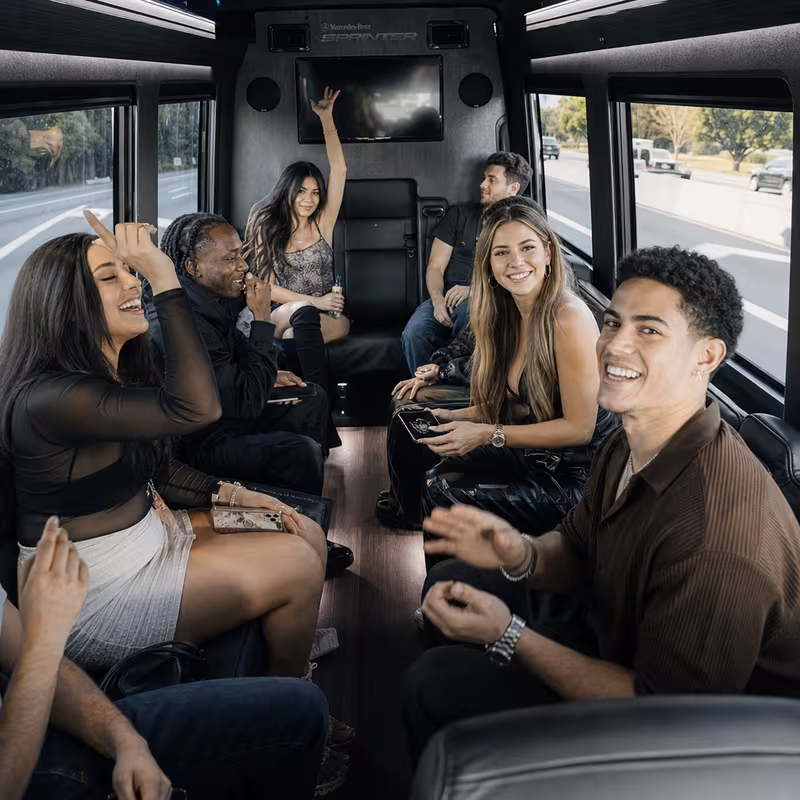 Group boarding a white charter bus for Concert Transportation transportation in Indianapolis