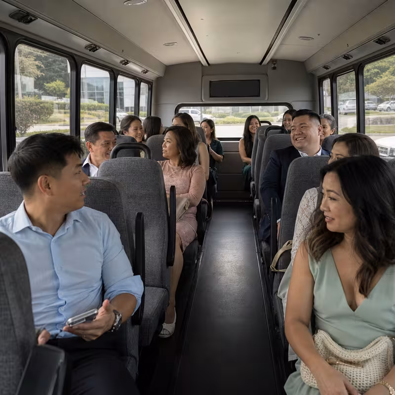 Group boarding a white charter bus for Private Event Transportation transportation in Indianapolis