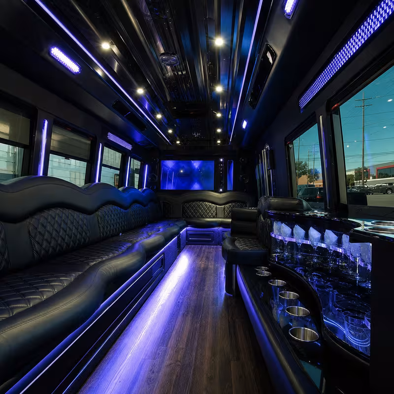 Party bus interior with wraparound leather seating and LED lighting in Indianapolis
