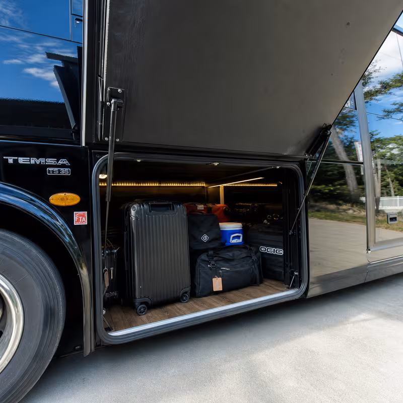 Party bus interior with wraparound leather seating and LED lighting in Indianapolis