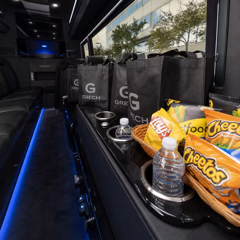 Party bus interior with wraparound leather seating and LED lighting in Indianapolis